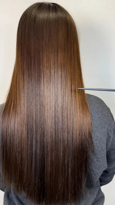 Manufacturer-provided Keratin Tropic after example showing smoother long brunette hair